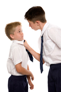 Older boy bullying younger one at school