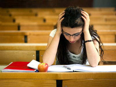 Girl looking distressed as she takes an exam