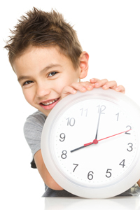 Young boy learning to tell the time
