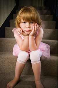 Young girl being disciplined by sitting on the naughty step