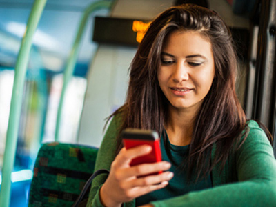 Woman communicating with school via text message