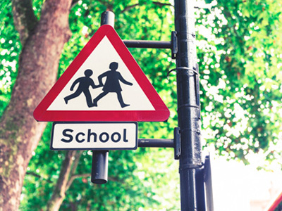 Road sign warning of children going to and from school