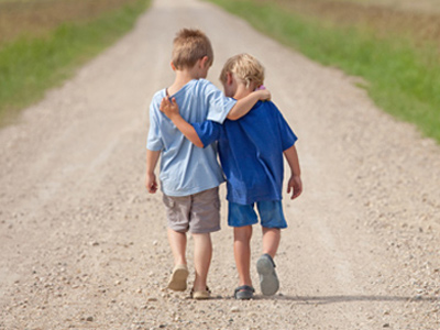 Autistic boy walking with his close friend