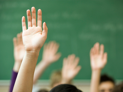 Hands raised by school pupils
