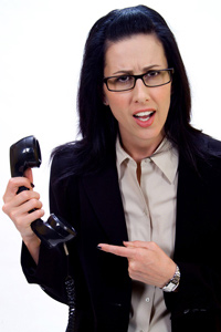Woman annoyed with cold caller on her telephone