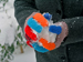 Woollen gloved hands holding a snowball