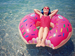 Girl on inflatable in water in the sun