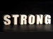 The word strong on a black background