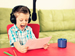 Boy reading aloud into microphone with headphones
