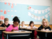 Grade 4 schoolchildren sitting at desks in classroom