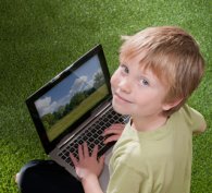 Young, smiling boy using a computer