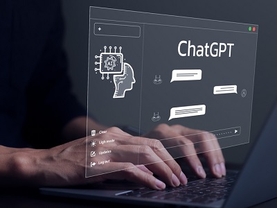 Hands typing on a laptop with a digital screen showing a ChatGPT interface, including speech bubbles, an AI brain icon, and menu options, symbolising interaction with AI.