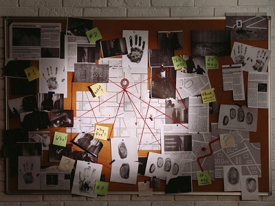 A corkboard covered in crime scene photos, handprints, fingerprints, newspaper clippings, and maps connected by red string, resembling a detective investigation wall.
