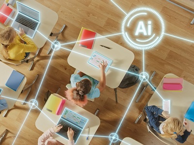 Top-down view of a classroom where children sit at desks using laptops and tablets, connected by glowing digital AI network lines, showing how artificial intelligence supports learning.
