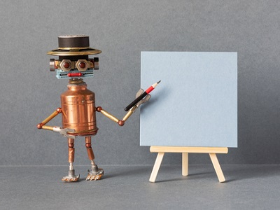A small robot made from metal parts wearing a black hat holds a red pencil and points at a blank canvas on an easel, ready to draw or create artwork.