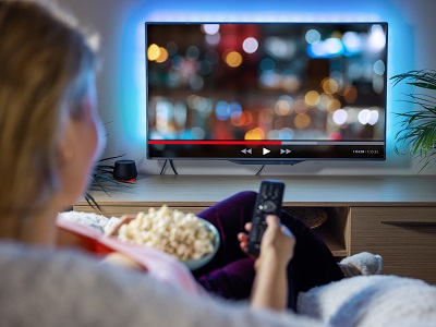 Smart TV showing a YouTube video being upscaled from standard definition to HD, with an on-screen notice about AI enhancement to improve picture clarity.