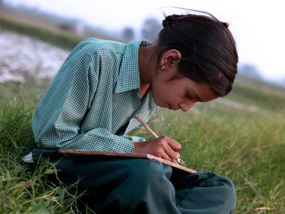 Child writing a story in their notebook