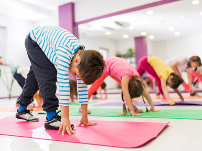 Kids exercising indoors on rubber mats
