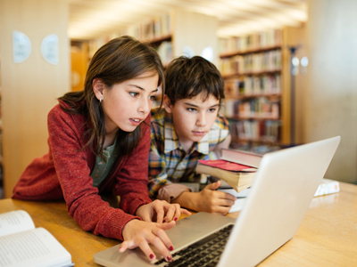 Grade 5 children in library on a computer