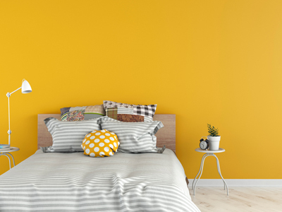 Modern bedroom with yellow walls