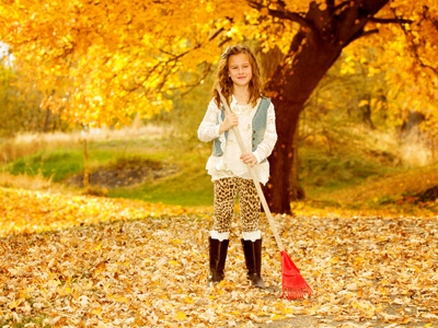 Girl raking up fall leaves
