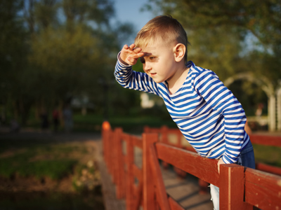 Child shielding his eyes from bright light