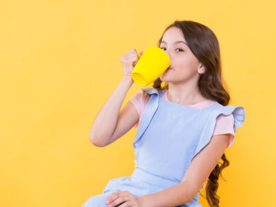 Child drinking a mug of tea