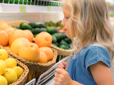 Child choosing oranges and lemons