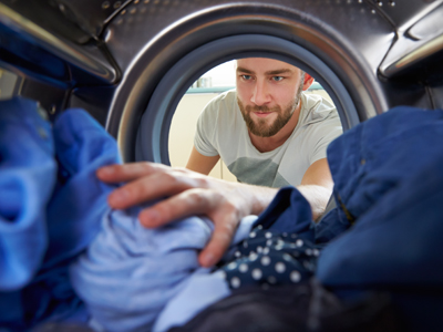 Man loading washing machine