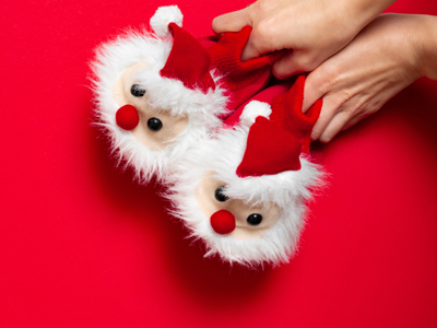 Child holding fluffy slippers