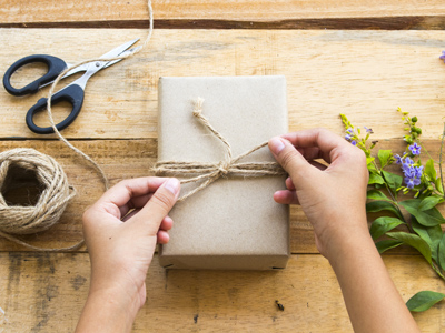 Child tying parcel with string