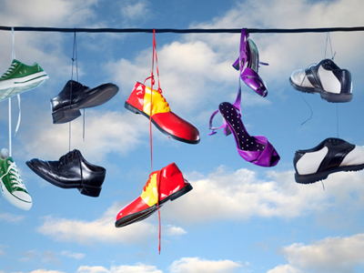 pairs of shoes hanging on a washing line