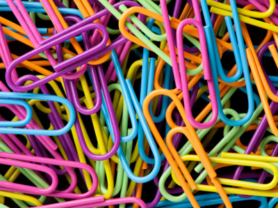 A collection of colourful paperclips.