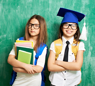 Two children looking pleased with their 11-Plus results
