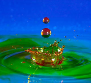 Colourful chemical droplets falling into a pool
