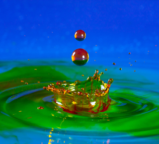 Colourful chemical droplets falling into a pool
