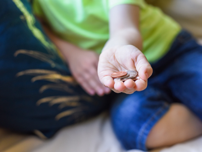 Child holding handful of coins