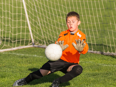 Child goalkeeper making save
