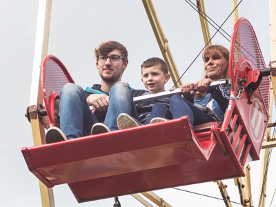 Child and parents on big wheel
