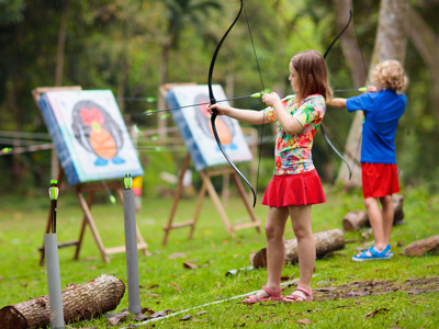 Children learning archery
