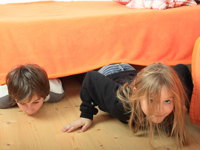 Children hiding under bed