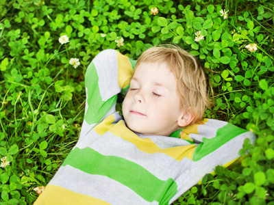 Child sleeping in garden