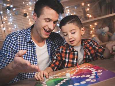 Child and father playing board game