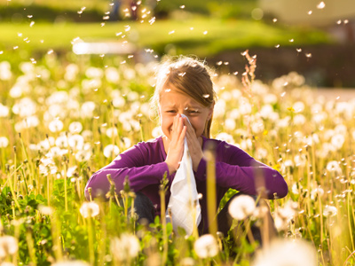 Child in meadow with hay fever