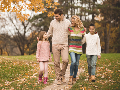 Happy family walking together in a park