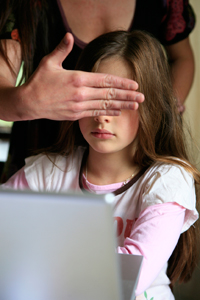 Mother protecting her daughter from viewing offensive online content