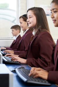 Secondary school class studying on computers