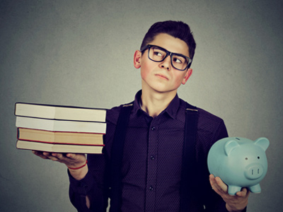 University student holding piggybank and textbooks