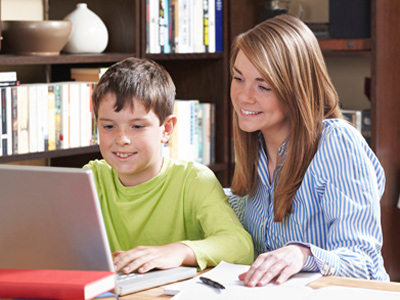 Home-schooled boy being helped by mother