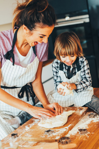 Mother and young child making food